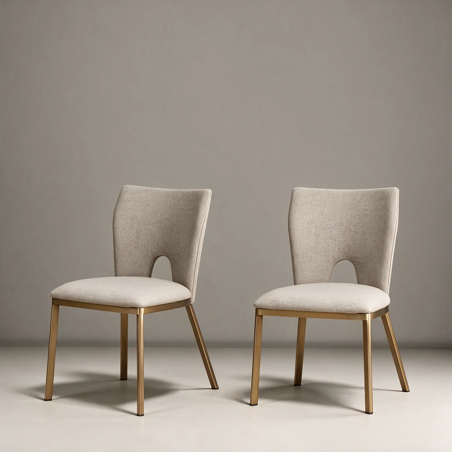 Set of Two Beige And Brass Upholstered Fabric Open Back Dining Side Chairs, three-quarter view